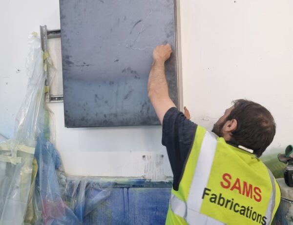 SAMS Fabrications engineer installing a steel cabinet on site