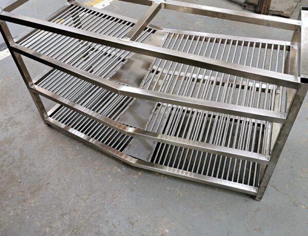 Stack of stainless steel slatted shelf racks