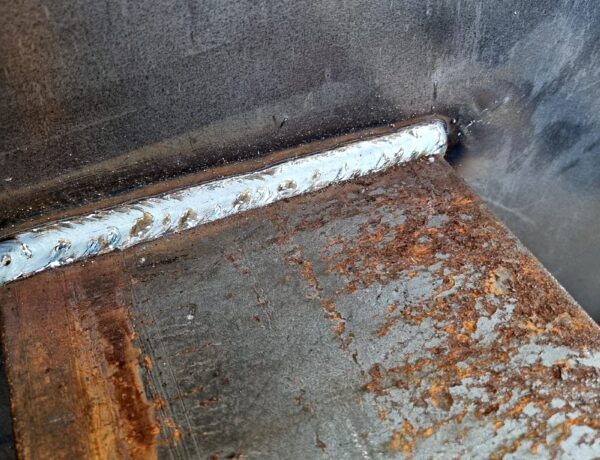 Welded seam close-up on a steel plate