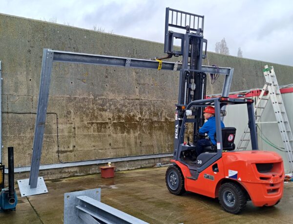 Steel frame being lifted into position on site