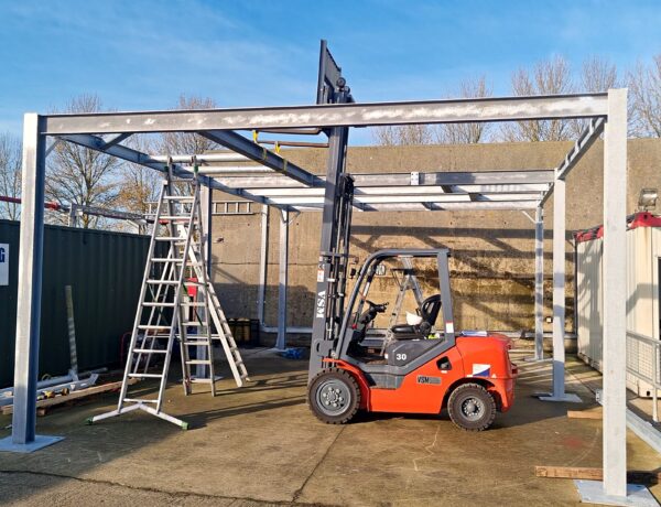 Steel canopy frame being erected on site with a forklift