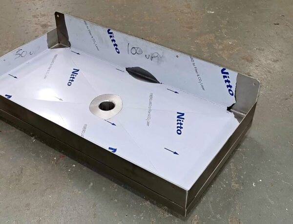 Stainless steel sink with pressing, protective film on