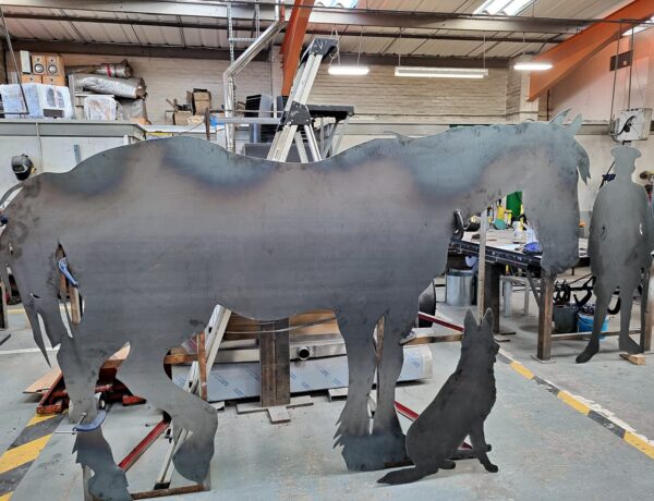 Laser-cut steel horse silhouette sculpture in the SAMS Fabrications workshop