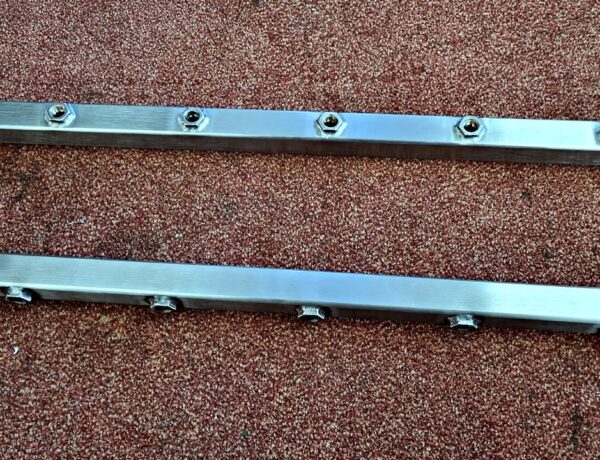 Pair of stainless steel mounting rails with welded fittings
