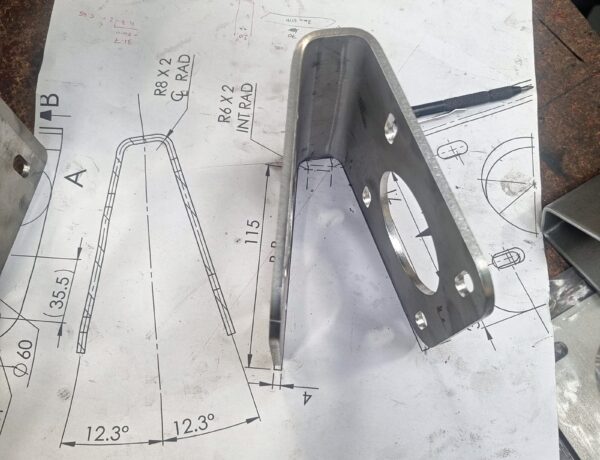 Laser-cut steel bracket on its engineering drawing