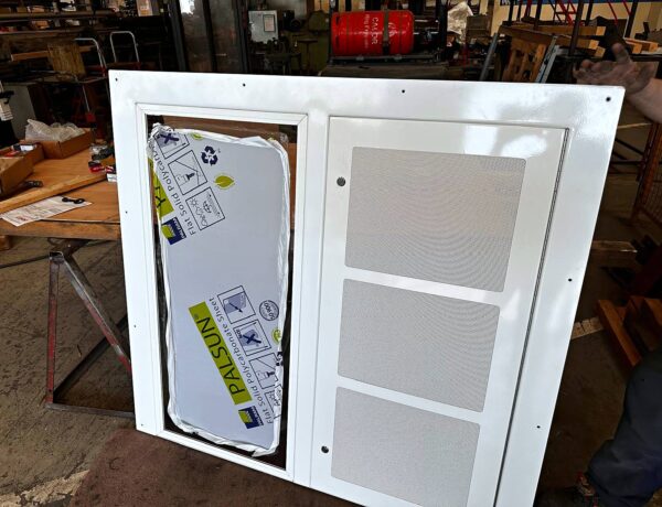 Door panel with perforated stainless steel insert